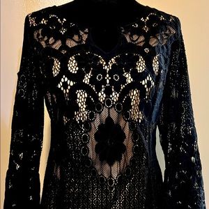 Women’s black lace top with nude garment underneath
